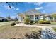 Charming one-story home featuring a cozy porch, manicured landscaping, and a welcoming entryway at 729 Winterside Dr, Apollo Beach, FL 33572