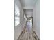 Long hallway with wood-look tile floors and multiple windows at 729 Winterside Dr, Apollo Beach, FL 33572