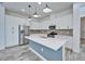 Bright kitchen features stainless steel appliances and a blue center island with pendant lighting at 729 Winterside Dr, Apollo Beach, FL 33572