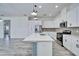 Bright kitchen features stainless steel appliances and a blue center island with pendant lighting at 729 Winterside Dr, Apollo Beach, FL 33572