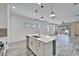 Modern kitchen with pendant lighting, stainless steel appliances, island, and tile flooring at 729 Winterside Dr, Apollo Beach, FL 33572