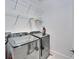 Well-equipped laundry room features side-by-side washer and dryer, with wire shelves for storage at 729 Winterside Dr, Apollo Beach, FL 33572