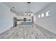 Open-concept living room with kitchen, tile floors, neutral paint, and plenty of natural light at 729 Winterside Dr, Apollo Beach, FL 33572