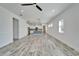 Open-concept living room with kitchen, tile floors, neutral paint, and plenty of natural light at 729 Winterside Dr, Apollo Beach, FL 33572