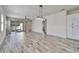 Bright living room featuring wood-look tile floors, modern lighting, and sliding glass doors to the patio at 729 Winterside Dr, Apollo Beach, FL 33572