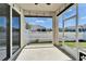Screened patio with lights and views of the backyard and fenced-in yard at 729 Winterside Dr, Apollo Beach, FL 33572