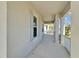 Covered front porch with white columns and trim, offering a welcoming entrance to the home at 729 Winterside Dr, Apollo Beach, FL 33572
