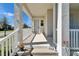 Inviting front porch with a well-lit entrance, decorative plants, and house number for easy identification at 729 Winterside Dr, Apollo Beach, FL 33572