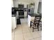 Eat-in kitchen features dark countertops, stainless steel appliances, and tile backsplash at 7413 Sherren Dr, Tampa, FL 33619