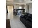 Open living space features tile floors, kitchen access, and natural light from sliding glass doors at 7413 Sherren Dr, Tampa, FL 33619