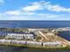 Aerial view of waterfront condos with marina, sandy beach and blue open water at 808 Bahia Del Sol Dr # 14, Ruskin, FL 33570