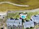 Aerial view of waterfront condos with a pool, landscaping, and a boat speeding through the water at 808 Bahia Del Sol Dr # 14, Ruskin, FL 33570
