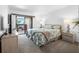 Cozy bedroom with a balcony access, and coastal-themed decor at 808 Bahia Del Sol Dr # 14, Ruskin, FL 33570
