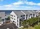 Coastal condo building features assigned parking, community pool, and partial Gulf views at 808 Bahia Del Sol Dr # 14, Ruskin, FL 33570