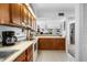 Kitchen features wooden cabinets, white countertops and appliances, and a beautiful view at 808 Bahia Del Sol Dr # 14, Ruskin, FL 33570