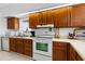 Bright kitchen features wooden cabinets, white appliances, and ample countertop space at 808 Bahia Del Sol Dr # 14, Ruskin, FL 33570
