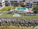 View of the community pool, lounge chairs, and the waterfront at 808 Bahia Del Sol Dr # 14, Ruskin, FL 33570