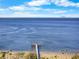 Beautiful waterfront view featuring a pier, beach, and the cityscape on the horizon at 808 Bahia Del Sol Dr # 14, Ruskin, FL 33570