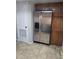 Kitchen featuring stainless steel refrigerator and matching wooden cabinets and tile flooring at 852 Creekway Ct, Brandon, FL 33511