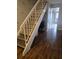 Inviting staircase featuring hardwood floors and white banister at 852 Creekway Ct, Brandon, FL 33511