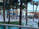 View of resort-style pool and BBQ area with beach beyond at 880 Mandalay Ave # N105, Clearwater Beach, FL 33767