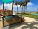 Outdoor kitchen features a built-in grill on the patio with beach views and palm trees at 880 Mandalay Ave # N105, Clearwater Beach, FL 33767