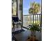 Balcony with a view of the bay featuring a chair, small table, potted plants, and nautical decor at 8901 Blind Pass Rd # 224, St Pete Beach, FL 33706