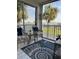 Balcony with a view of the bay featuring two chairs, a table, and nautical decor for an inviting outdoor space at 8901 Blind Pass Rd # 224, St Pete Beach, FL 33706