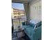 Cozy, covered balcony seating area with views of the complex and bright natural light at 8901 Blind Pass Rd # 224, St Pete Beach, FL 33706
