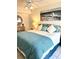 Coastal-themed bedroom featuring a comfy bed, ocean artwork, and a ceiling fan for a relaxing ambiance at 8901 Blind Pass Rd # 224, St Pete Beach, FL 33706