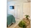 Bedroom featuring a bed, dresser, closet, and mounted television creating a functional and stylish living space at 8901 Blind Pass Rd # 224, St Pete Beach, FL 33706