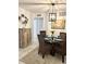 Cozy dining area with wicker chairs, a glass table, and a coastal-themed painting at 8901 Blind Pass Rd # 224, St Pete Beach, FL 33706