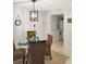 Charming dining area with a glass table, wicker chairs, and stylish light fixture at 8901 Blind Pass Rd # 224, St Pete Beach, FL 33706