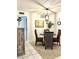 Charming dining space with wicker chairs, a glass table, and a beach-inspired painting at 8901 Blind Pass Rd # 224, St Pete Beach, FL 33706