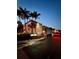 Nighttime view of a gated entrance to a condo complex with palm trees and security at 8901 Blind Pass Rd # 224, St Pete Beach, FL 33706