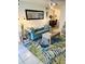 Bright living room with a plush sofa, tropical rug, and view to dining area at 8901 Blind Pass Rd # 224, St Pete Beach, FL 33706