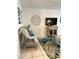 Cozy living room featuring wicker seating, tropical rug, and entertainment center at 8901 Blind Pass Rd # 224, St Pete Beach, FL 33706