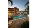 Night view of community pool with lounge chairs, lighting and views of the boat docks at 8901 Blind Pass Rd # 224, St Pete Beach, FL 33706