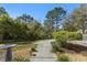 Serene backyard with landscaped greenery, and a concrete path at 10405 Villa View Cir # 10405, Tampa, FL 33647