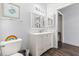 Bathroom featuring a white vanity, toilet, framed turtle art, and dark flooring at 10405 Villa View Cir # 10405, Tampa, FL 33647