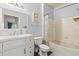 Clean bathroom featuring a white vanity, a toilet, and a shower-tub combo with a white tile surround at 10405 Villa View Cir # 10405, Tampa, FL 33647