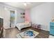 Charming bedroom featuring wood-look floors, a ceiling fan, and a playful decor at 10405 Villa View Cir # 10405, Tampa, FL 33647