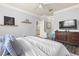 Bright bedroom featuring wood-look floors, a ceiling fan, and a coordinating dresser at 10405 Villa View Cir # 10405, Tampa, FL 33647
