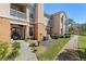 Exterior view of a multi-story building with a patio, walkway, and landscaped grounds at 10405 Villa View Cir # 10405, Tampa, FL 33647