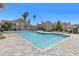 Community pool features a large swimming area with brick paved deck and lounge chairs with nearby apartment buildings at 10405 Villa View Cir # 10405, Tampa, FL 33647