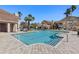 View of community pool featuring palm trees, lounge chairs, and a clubhouse in an inviting outdoor space at 10405 Villa View Cir # 10405, Tampa, FL 33647