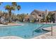 Inviting community pool with a clubhouse and chairs, offering a refreshing outdoor amenity for residents at 10405 Villa View Cir # 10405, Tampa, FL 33647