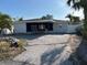 Charming exterior view of the house, showcasing the carport and ample parking space at 11110 1St E St, Treasure Island, FL 33706