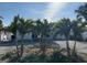 Inviting front yard featuring palm trees providing a tropical and relaxed atmosphere at 11110 1St E St, Treasure Island, FL 33706