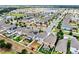 Areal view of a neighborhood including a large pond and manicured lawns at 11201 Hudson Hills Ln, Riverview, FL 33579